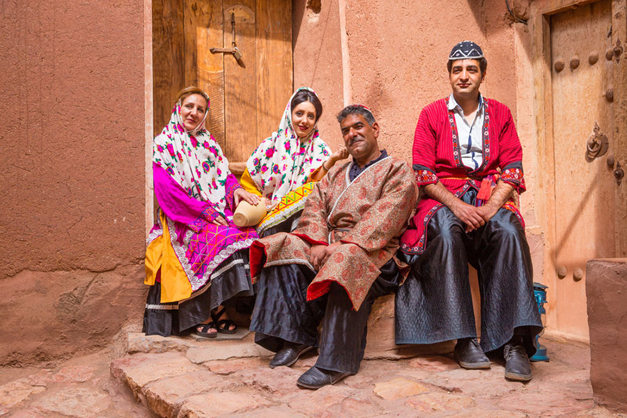 An Iranian Traditional clothing which belongs to Bakhtiary nomads among white lambs, Iransense Travel Agency